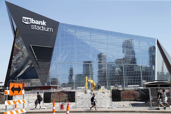 The Minneapolis skyline is reflected in the new U.S. Bank Stadium in Minneapolis as it nears completion for the $1.2 billion home of the Minnesota Vik