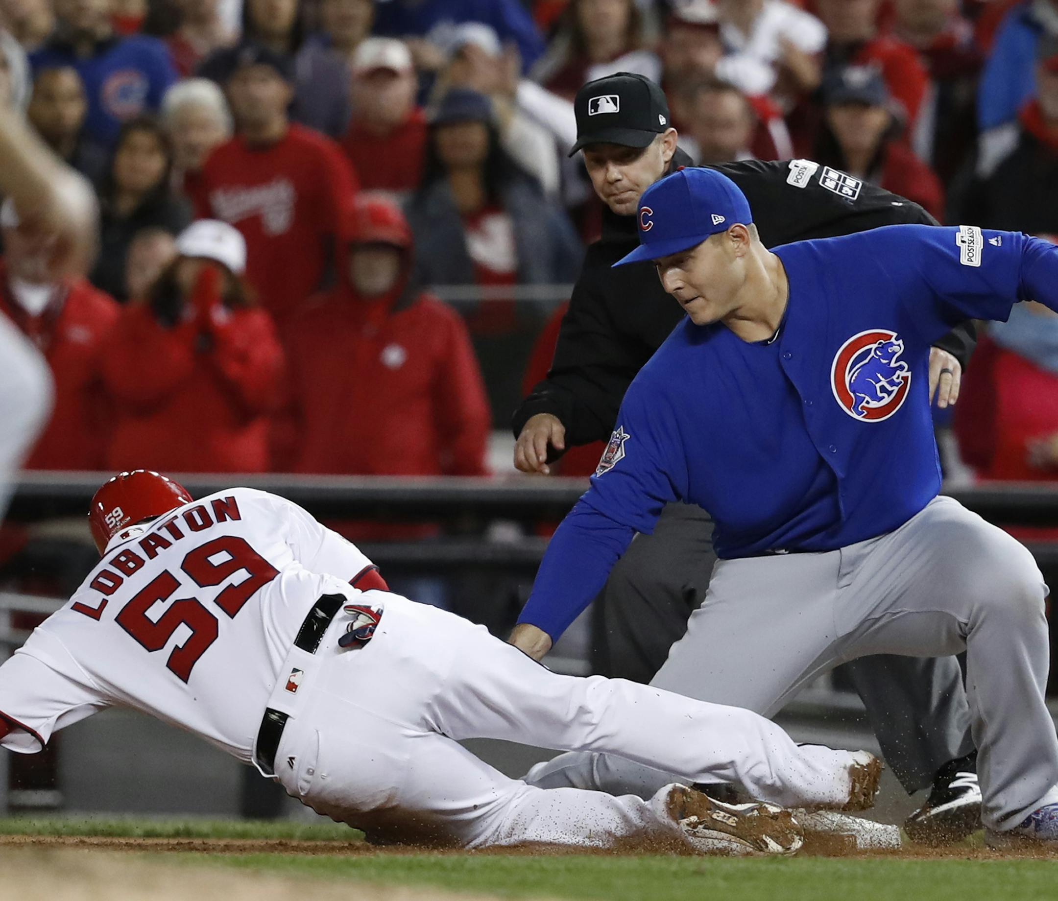 Chicago Cubs first baseman Anthony Rizzo (44) picks off Washington Nationals' Jose Lobaton on a throw from catcher Willson Contreras during the eighth inning in Game 5 of baseball's National League Division Series against the Chicago Cubs, at Nationals Park, early Friday, Oct. 13, 2017, in Washington. The Cubs challenged the call on the field and it was overturned on review. (AP Photo/Pablo Martinez Monsivais)