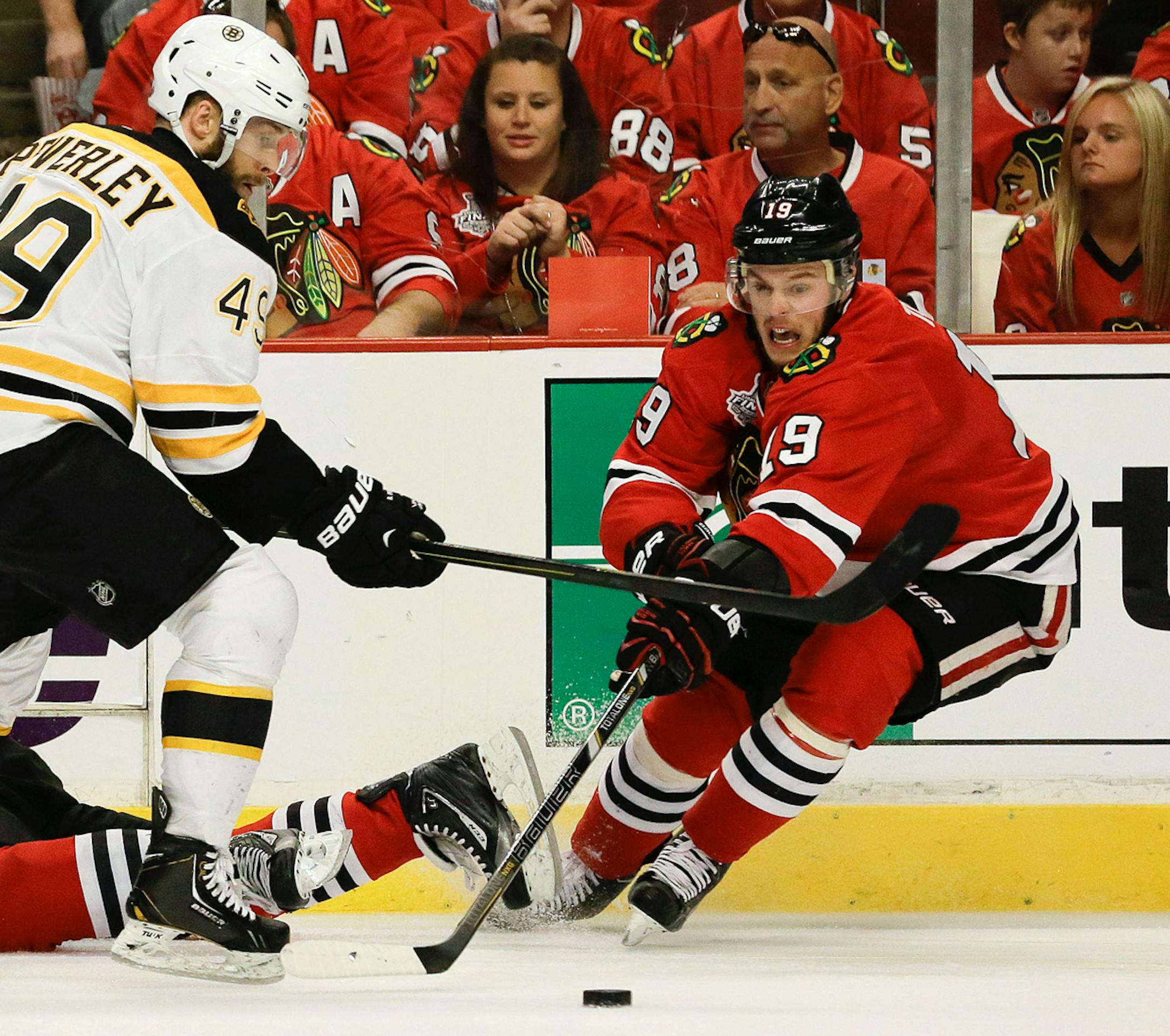 Blackhawks coach Joel Quenneville says he hopes forward Jonathan Toews (right) will be able to play in Game 6 of the Stanley Cup Final against the Boston Bruins on Monday. Toews did not play in the third period of Chicago's 3-1 victory over Boston in Game 5 on Saturday night because of an undisclosed injury.
