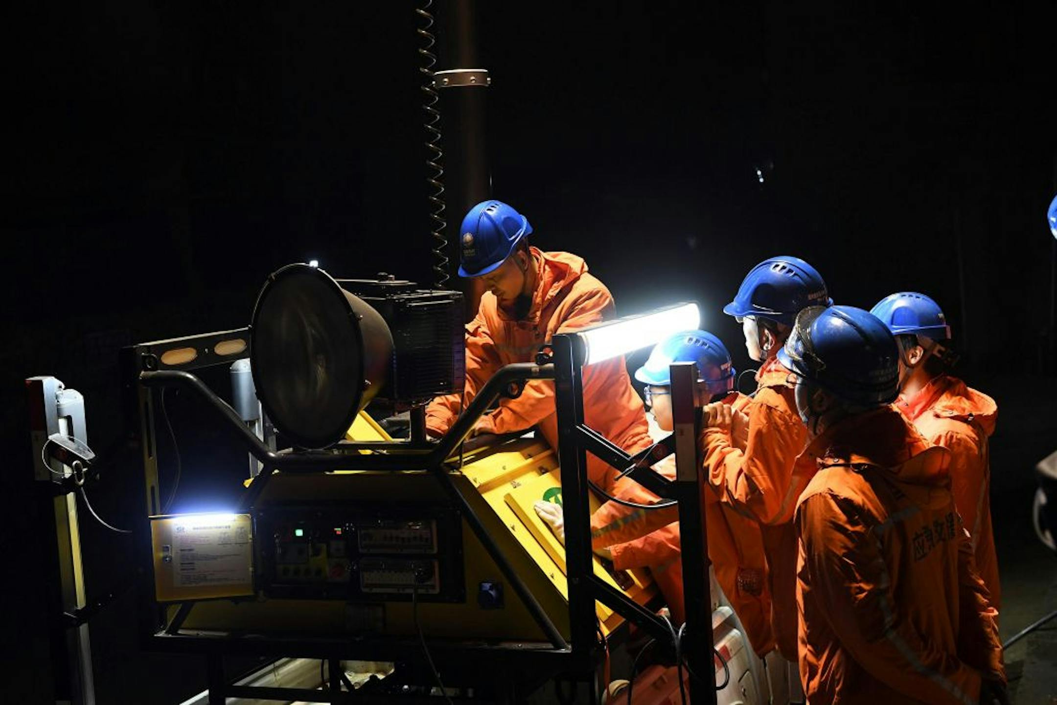 Rescuers adjust an emergency generator at the Diaoshuidong coal mine in southwestern China's Chongqing on December 5, 2020, after a carbon monoxide leak at the facility left 18 dead, with rescue efforts under way to reach five others still trapped underground.