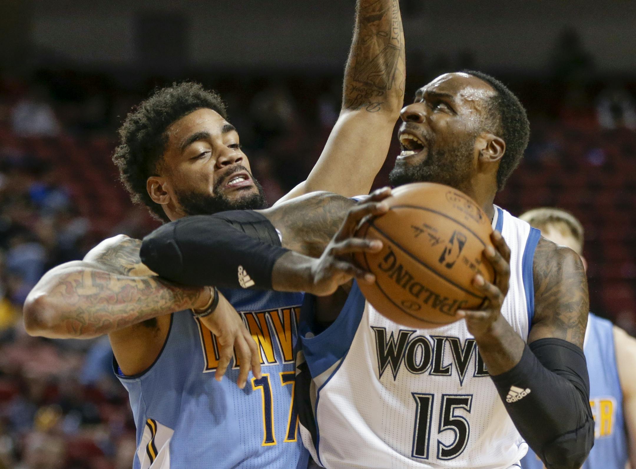 Denver Nuggets guard D.J. Kennedy (17) defends Minnesota Timberwolves center Shabazz Muhammad (15) during the second half of an NBA preseason basketball game in Lincoln, Neb., Wednesday, Oct. 12, 2016. The Timberwolves won 105-88. (AP Photo/Nati Harnik)