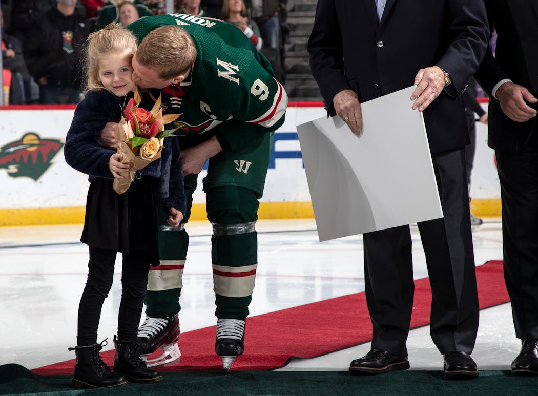 Koivu gave his daughter a kiss as he was honored for his 1,000th game with the Wild in 2019.
