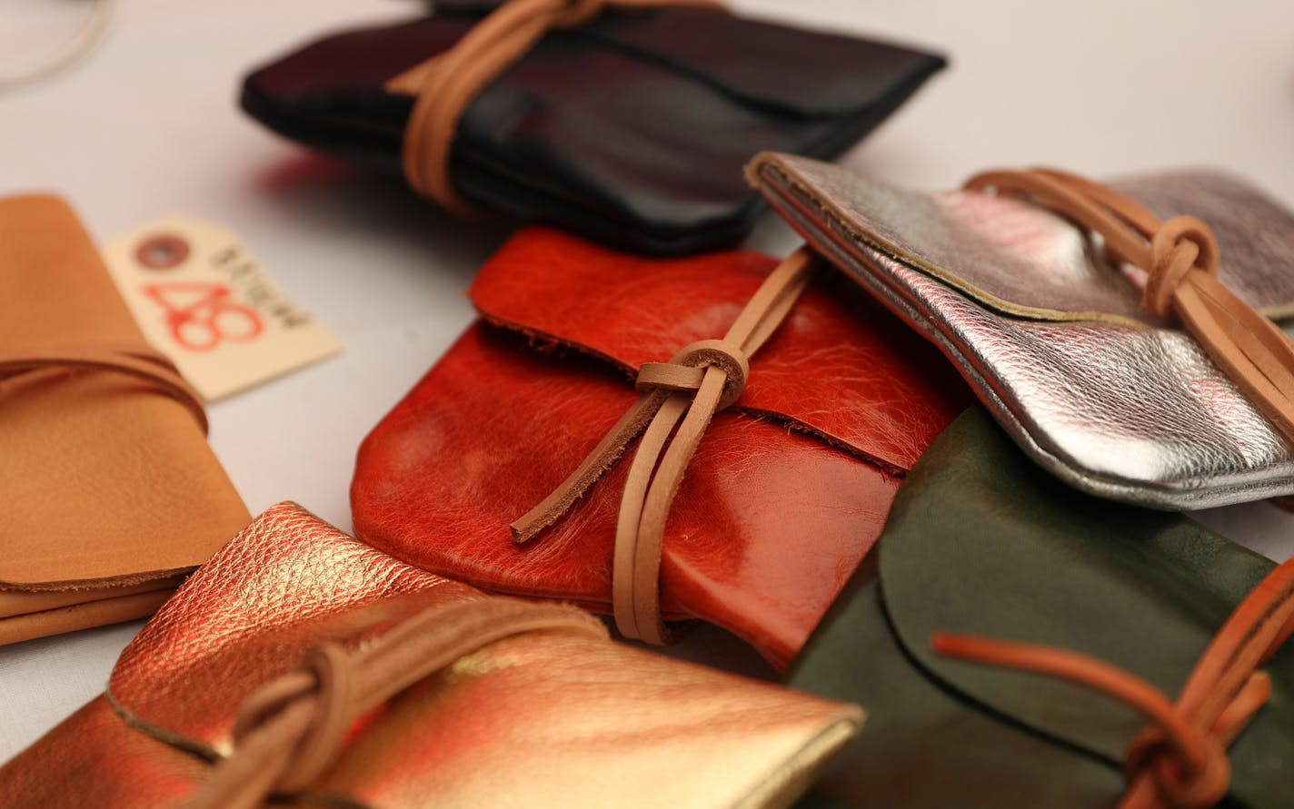 Leather bags made by Talin Spring sat for sale at her stand, Spring Finn & Co., in the Mill City Farmers Market.