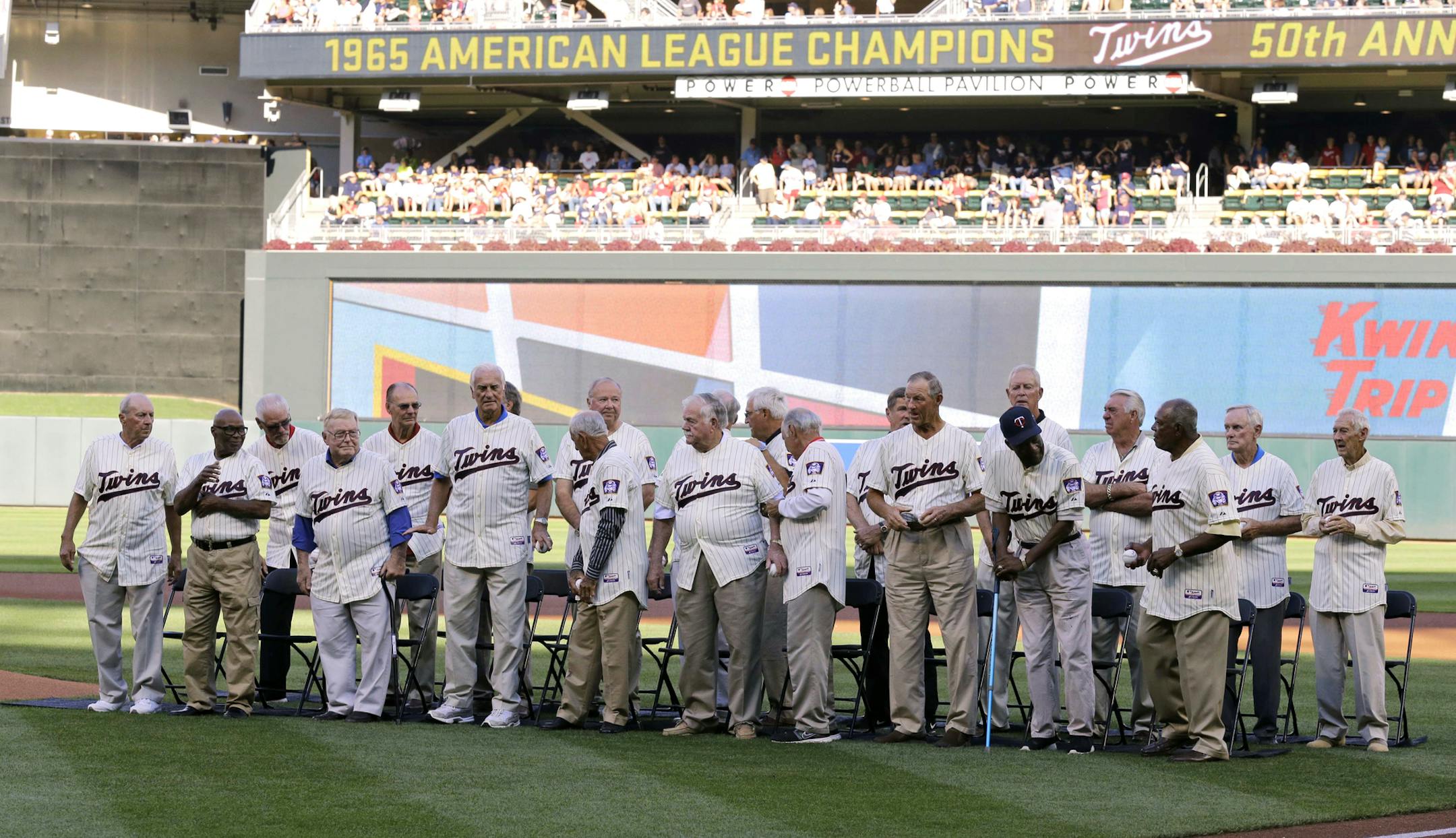 Members of the 1965 Minnesota Twins gather on the field during a 1965 American League Championship Anniversary celebration prior to the Twins baseball game against the Seattle Mariners in Minneapolis, Saturday, Aug. 1, 2015. (AP Photo/Ann Heisenfelt)