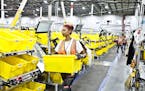 An employee sorts bins at an Amazon warehouse in Florence, N.J., Aug. 29, 2017. Amazon is on the forefront of automation, finding new ways of getting 