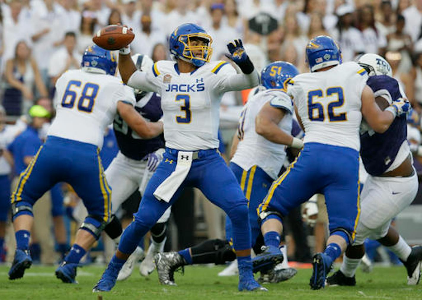 South Dakota State quarterback Taryn Christion (3) passes as linemen Charlie Harmon (68) and Jacob Ohnesorge (62) block TCU defenders during the first half of an NCAA college football game Saturday, Sept. 3, 2016, in Fort Worth, Texas. (AP Photo/LM Otero)