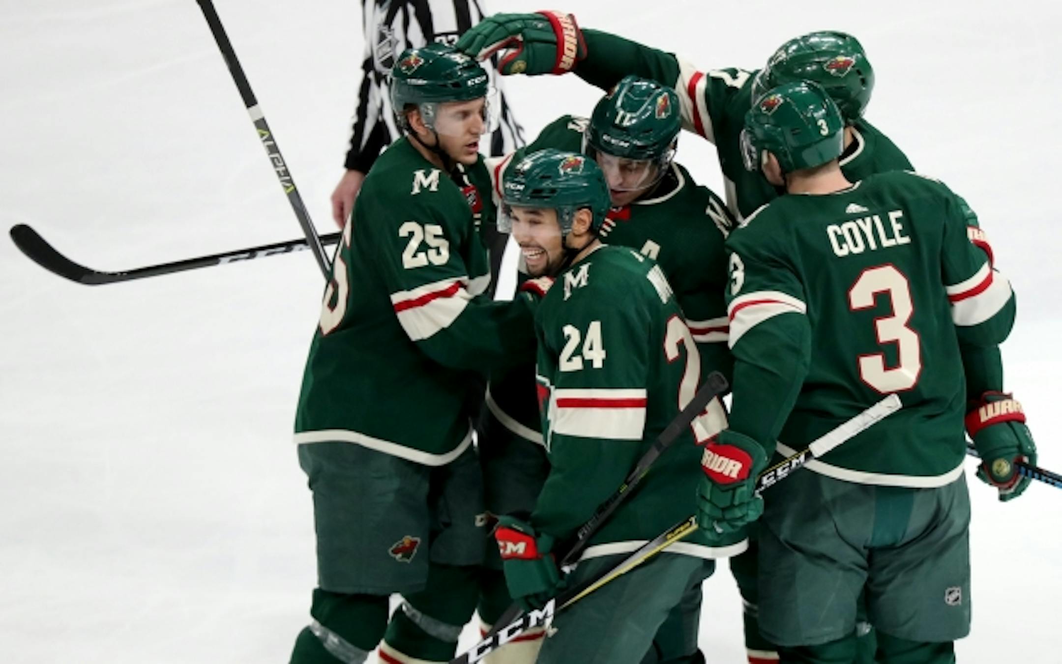 The Minnesota Wild's Matt Dumba (24) looks over at the Wild bench after scoring his second goal of the game and celebrating with teammates. The Wild beat the Winnipeg Jets 4-1 Saturday, Jan. 13, 2018, at the Xcel Energy Center in St. Paul, MN. ]