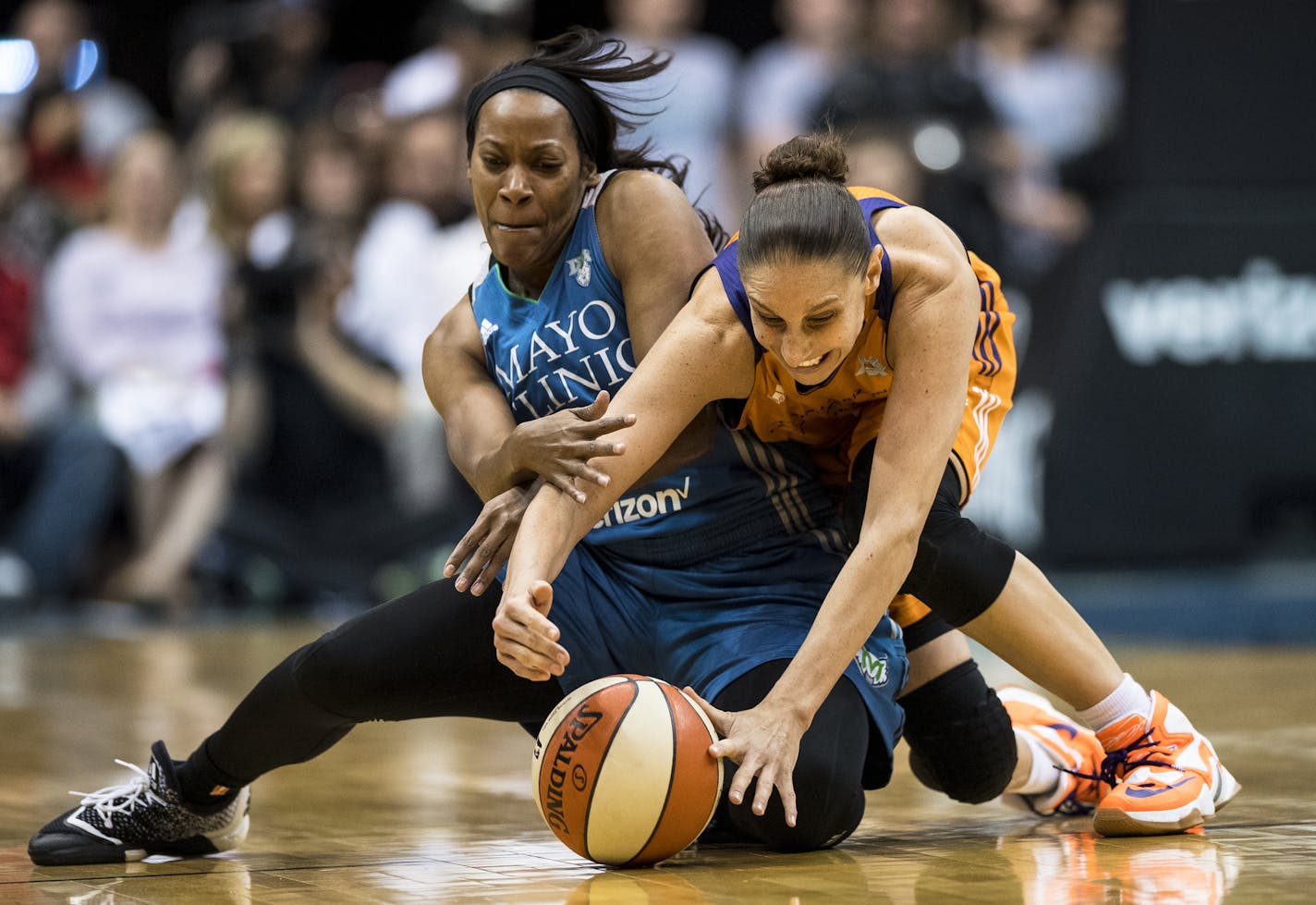 Minnesota Lynx guard Jia Perkins (7) and Phoenix Mercury guard Diana Taurasi (3) collided while chasing down a loose ball in the closing seconds of the season opener.