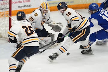 Wayzata's Hawke Huff (18) looks to clear the puck in overtime of the holiday tournament between Minnetonka and Wayzata Friday, Dec. 29, 2023 at the Pl