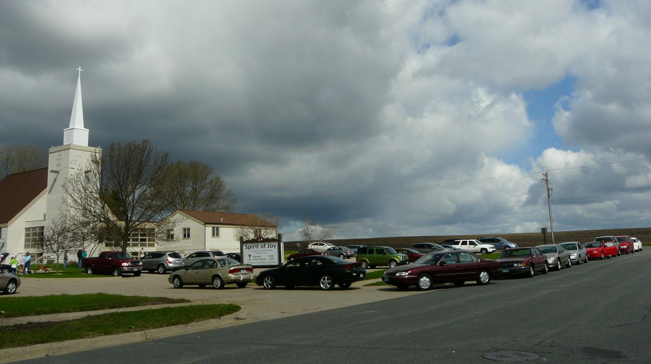 Photo by David Peterson There was a two block long wait outside Spirit of Joy Church, Lakeville, on a recent Saturday morning after the church offered free oil changes for single moms.