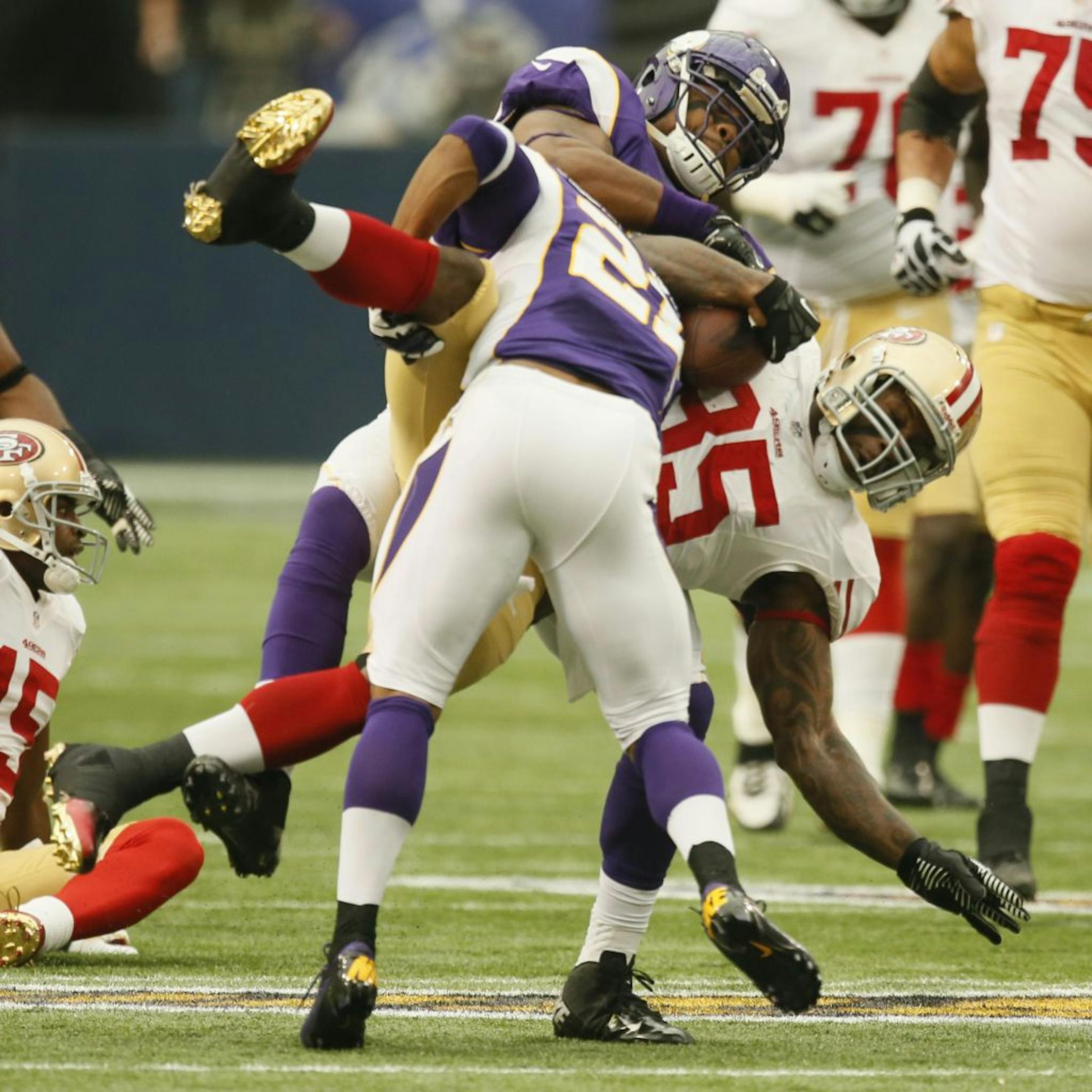 With big hits like this one by Josh Robinson, front, and Everson Griffen on 49ers tight end Vernon Davis, the Vikings matched San Francisco's physical play and scored a 24-13 victory at home on Sept. 23.