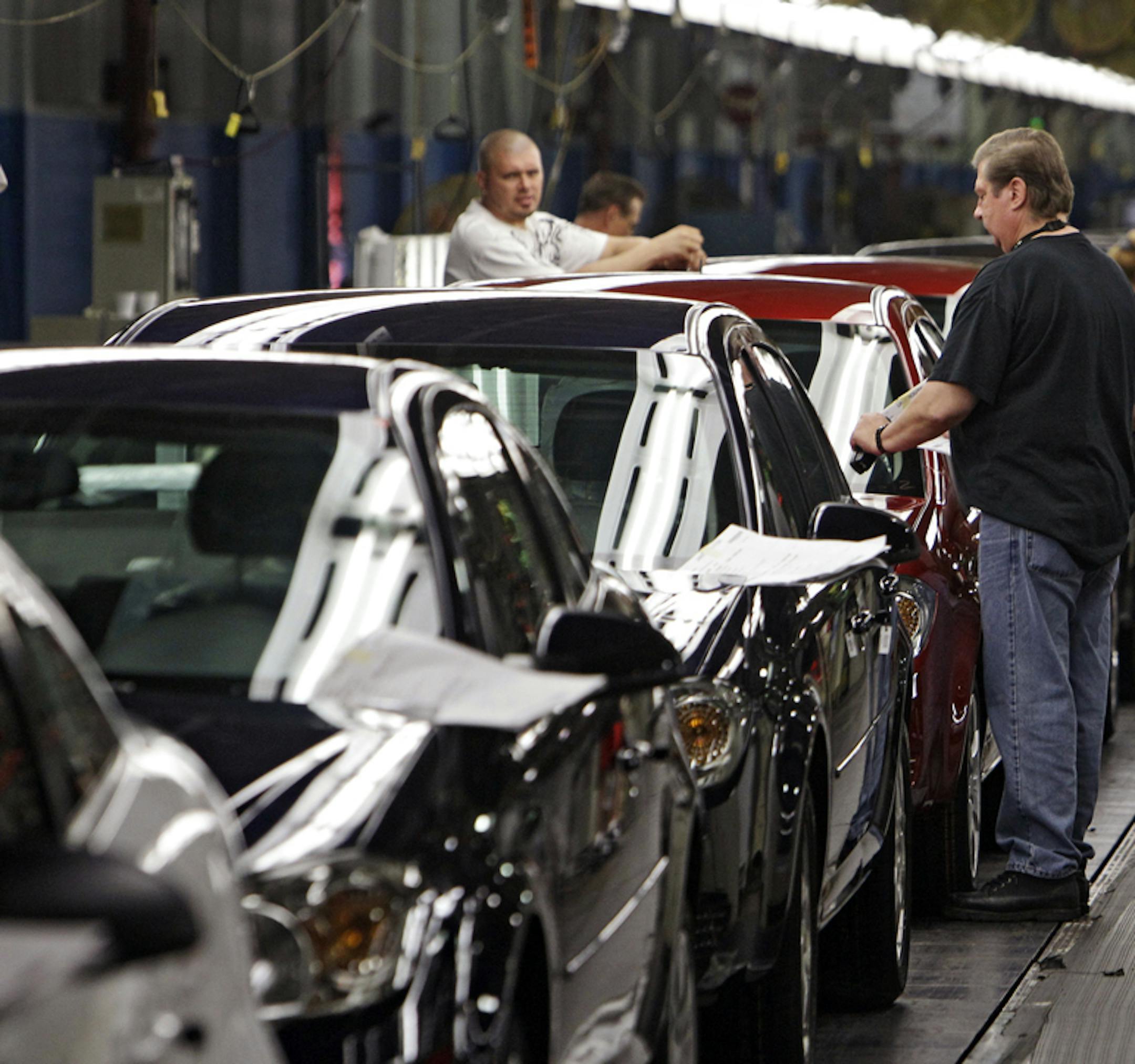 FILE - In this Tuesday, June 15, 2010, file photo, workers at General Motors' Lordstown Assembly plant in Lordstown, Ohio, put the final touches on Chevy Cobalts. One of the last industrial anchors in what was once the heart of manufacturing in Ohio is now on life support after General Motors announced Monday, Nov. 26, 2018, it will stop small-car production at its Lordstown assembly plant and consider closing it for good. (AP Photo/Mark Duncan, File)