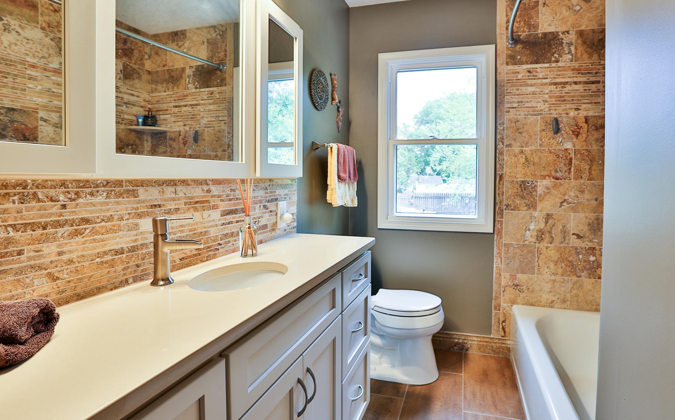 Stonehearth Remodeling tore out a closet to create space for a vanity and stone backsplash in the bathroom. The home is #44 on the tour, in St. Louis Park.
