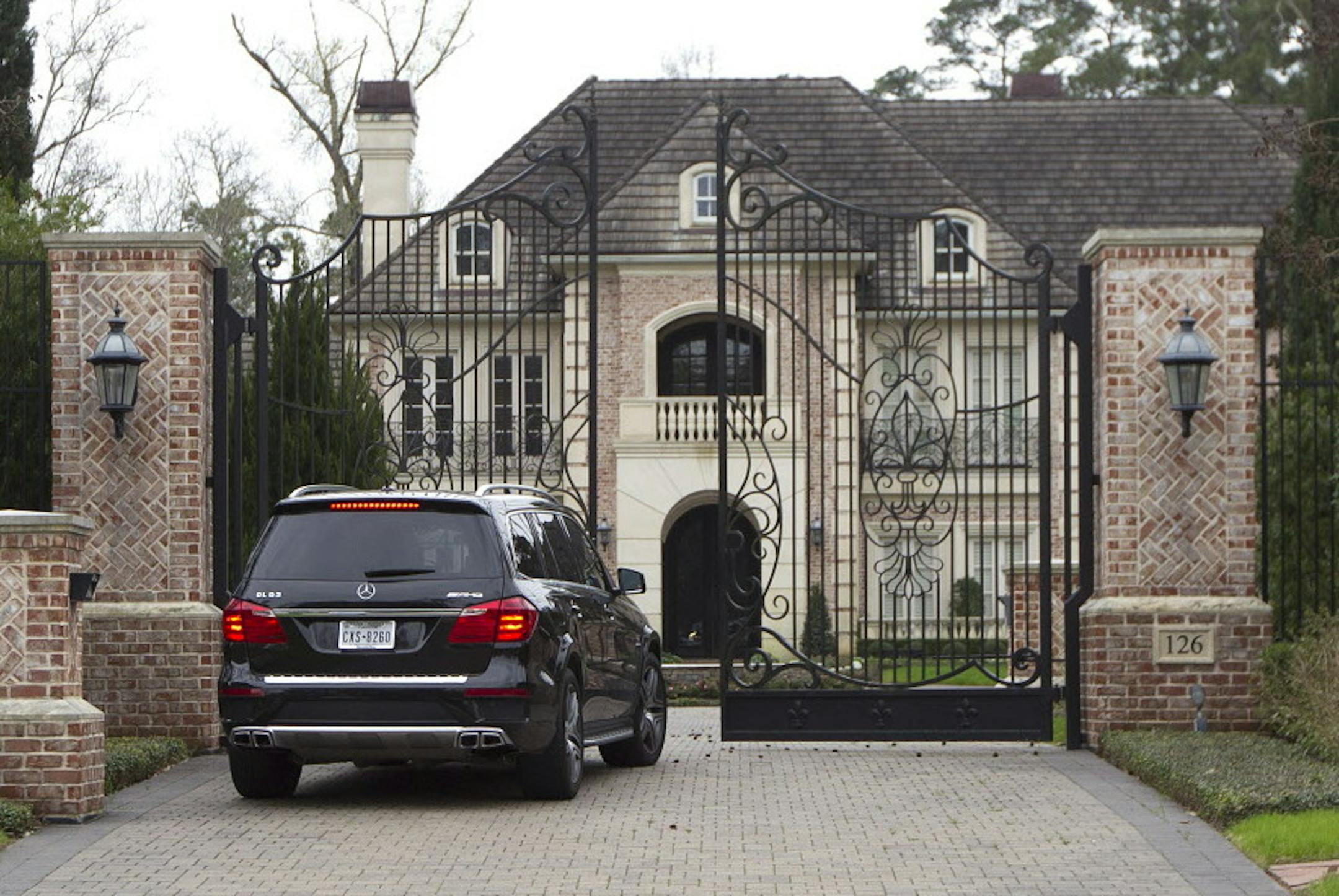 A car enters a gate to the home of NFL running back Adrian Peterson Wednesday, March 4, 2015, near Houston. Minnesota Vikings head coach Mike Zimmer and GM Rick Spielman plan to travel to Peterson's home near Houston on Wednesday to meet with their disgruntled star running back, a person with knowledge of the situation told The Associated Press. The person requested anonymity because neither side was publicly discussing the process. (AP Photo/ The Courier, Jason Fochtman) ORG XMIT: MIN2015030419