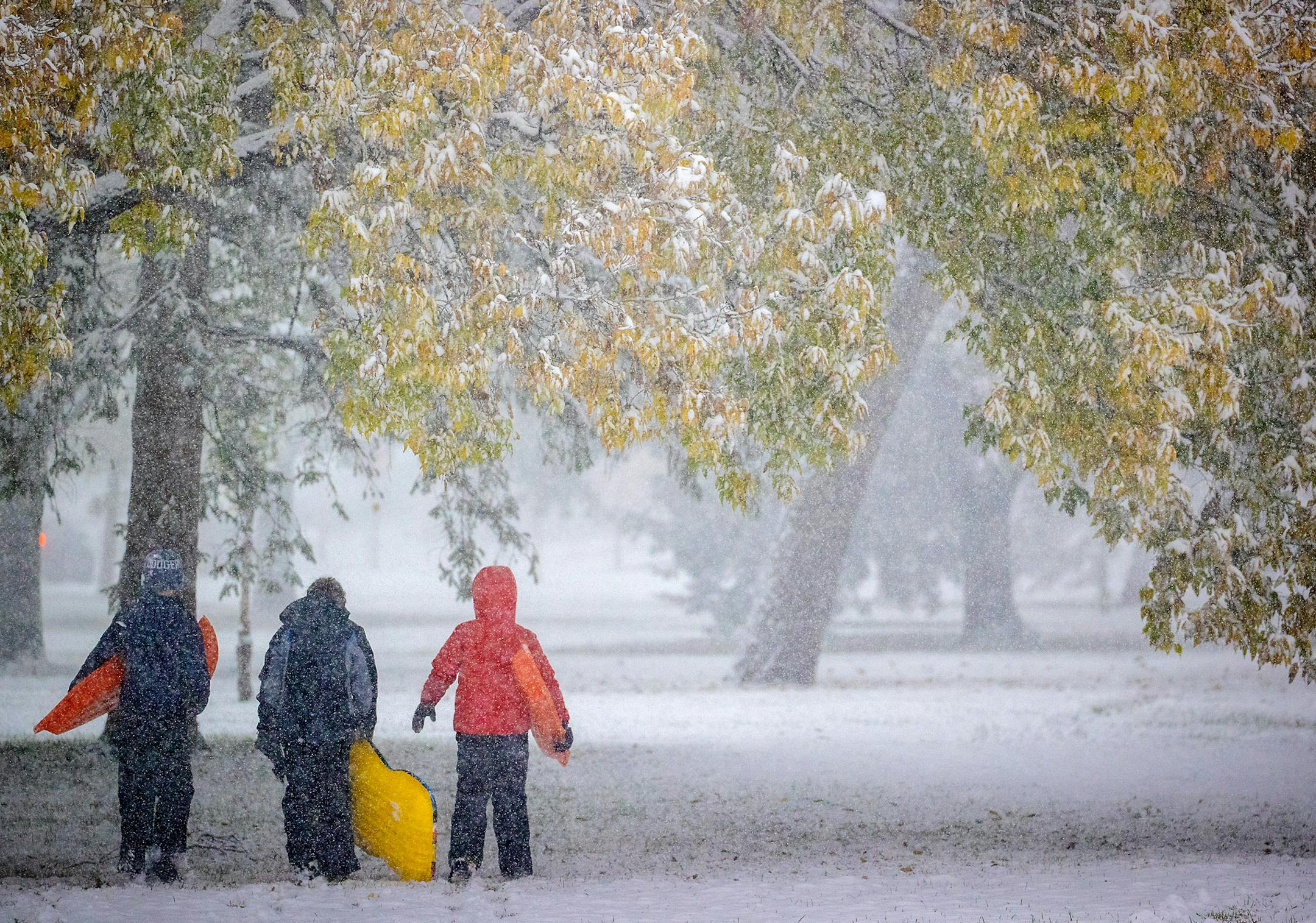 Atticus Saunders, 13, Keller Lindstrom, 10, and Fritz Saunders, 11, left to right, made their way through the snow after sledding near Lake Nokomis in Minneapolis. ] ELIZABETH FLORES • liz.flores@startribune.com
