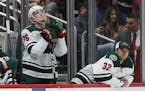 Minnesota Wild defenseman Nick Seeler (36) and goaltender Alex Stalock (32) pause on the team bench as time expires during the third period of an NHL 