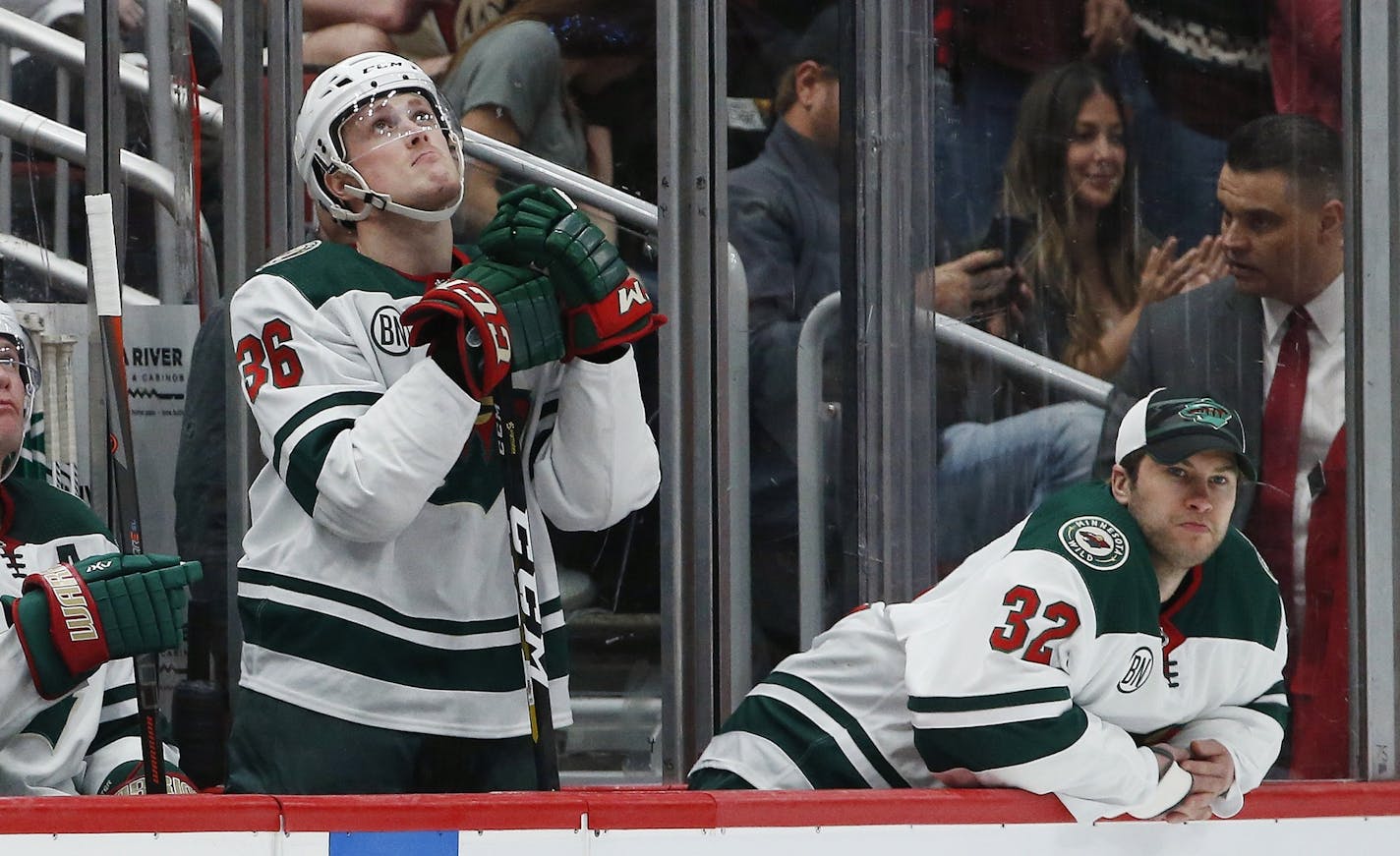 Minnesota Wild defenseman Nick Seeler (36) and goaltender Alex Stalock (32) pause on the team bench as time expires during the third period of an NHL hockey game against the Arizona Coyotes Sunday, March 31, 2019, in Glendale, Ariz. The Coyotes defeated the Wild 4-0. (AP Photo/Ross D. Franklin)