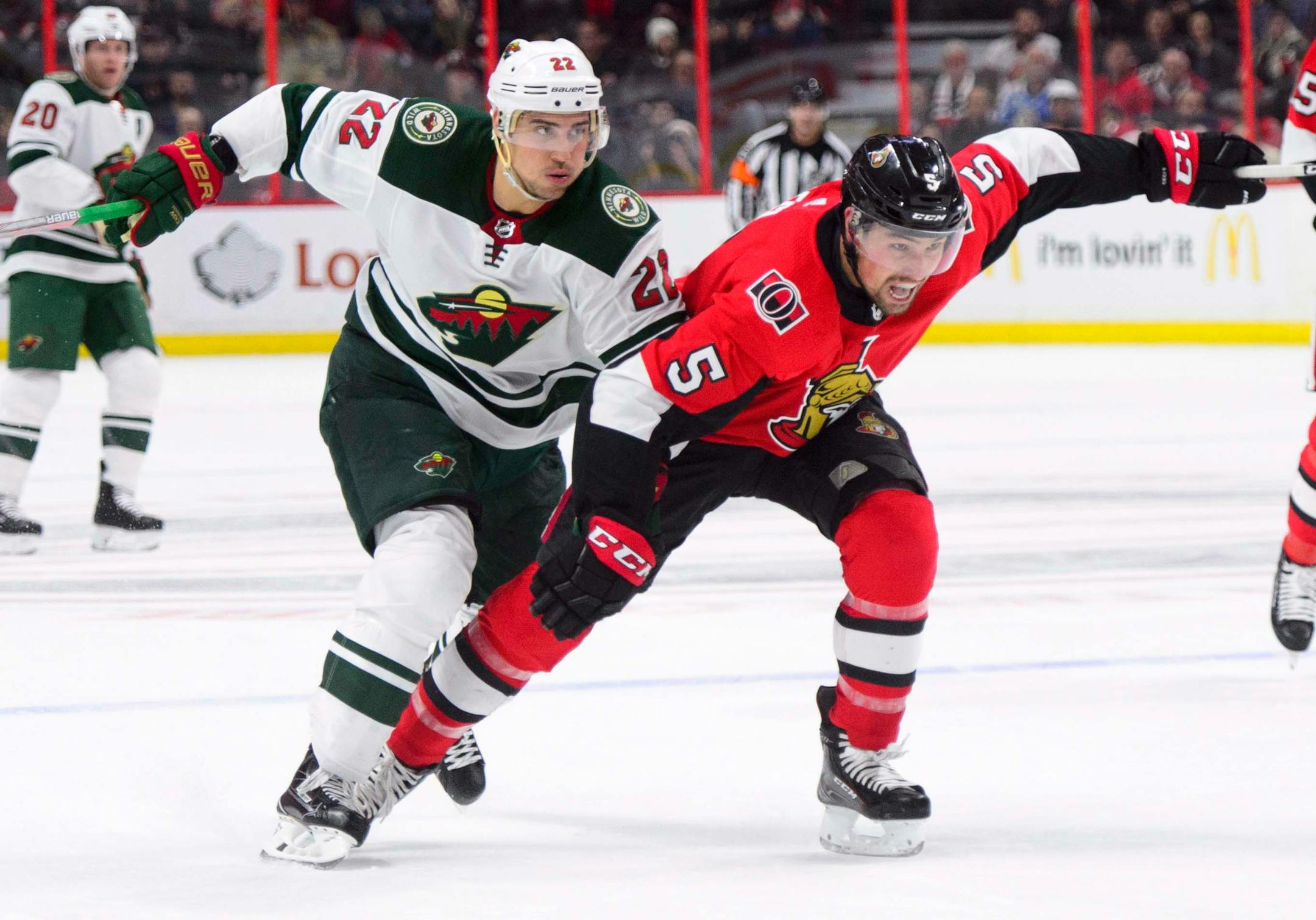 Minnesota Wild's Nino Niederreiter, left, fights to get ahead of Ottawa Senators' Cody Ceci during first period NHL hockey action in Ottawa on Tuesday, Dec. 19, 2017. (Sean Kilpatrick/The Canadian Press via AP)
