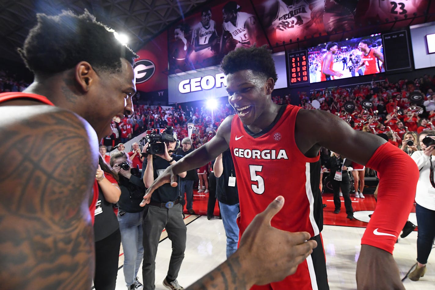 Georgia guard Anthony Edwards (5) celebrates with forward Mike Peake after the team's NCAA college basketball game against Auburn, Wednesday, Feb. 19, 2020, in Athens, Ga. Georgia won 65-55. (AP Photo/John Amis) ORG XMIT: GAJA106