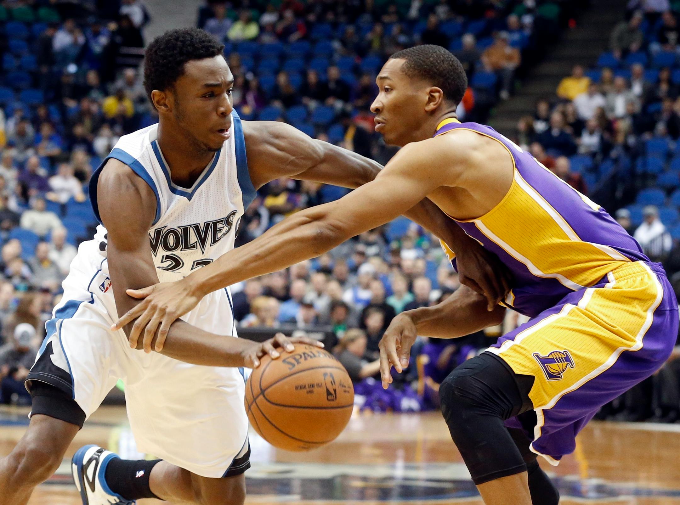 Minnesota Timberwolves� Andrew Wiggins drives as Los Angeles Lakers� Wesley Johnson defends during the first quarter of an NBA basketball game, Wednesday, March 25, 2015, in Minneapolis. (AP Photo/Jim Mone)