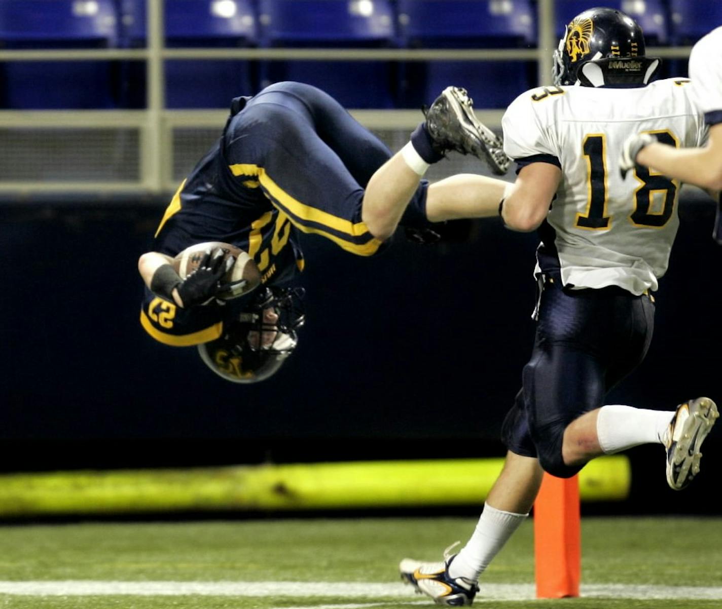 JEFFREY THOMPSON •¤jthompson@startribune.com Minneapolis, MN - Nov. 24, 2007 - 00000447C Totino-Grace's Micah Koehn dove into the endzone to score his team's winning touchdown on the last play of the game, defeating Mahtomedi 13-8 for the Class 4A Prep Bowl title Saturday. ORG XMIT: MIN2017112117115939