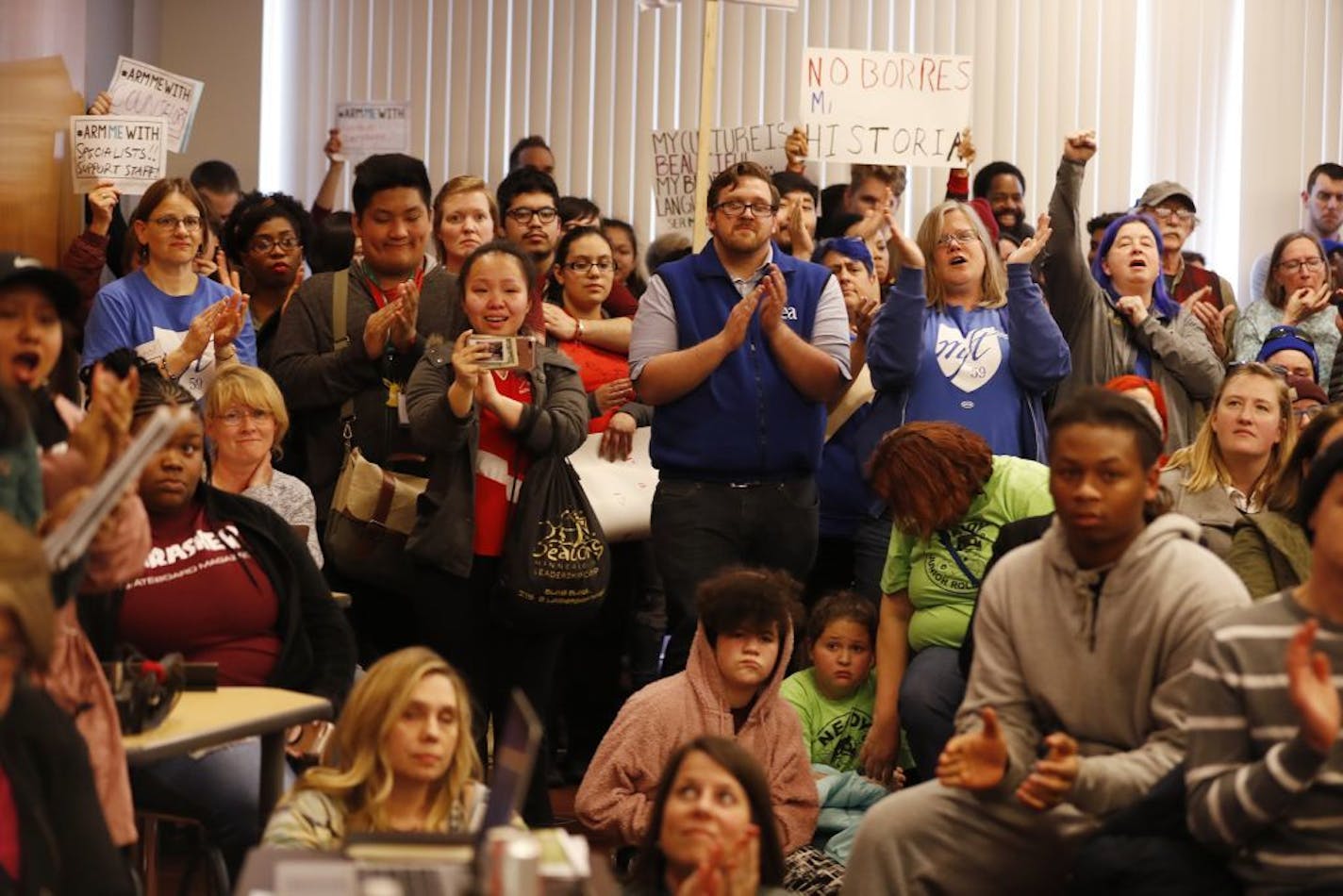 The crowd cheers a speaker during the public comment period.