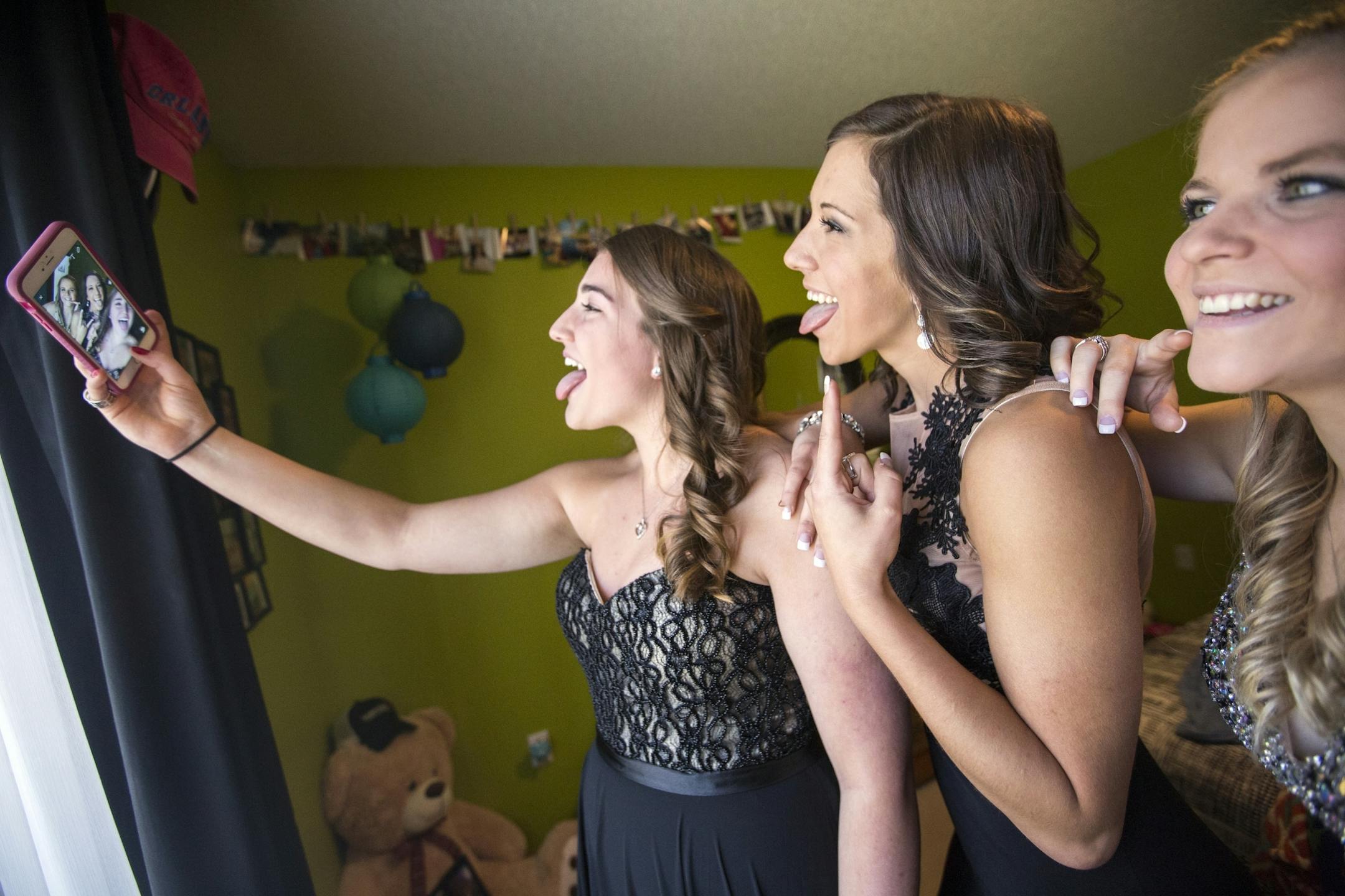 All seniors at Eveleth-Gilbert High School, Logan Rozinka, from left, Baylee Hilfers and Baylee Hanson take selfies before prom in Hilfers' room in Fayal.