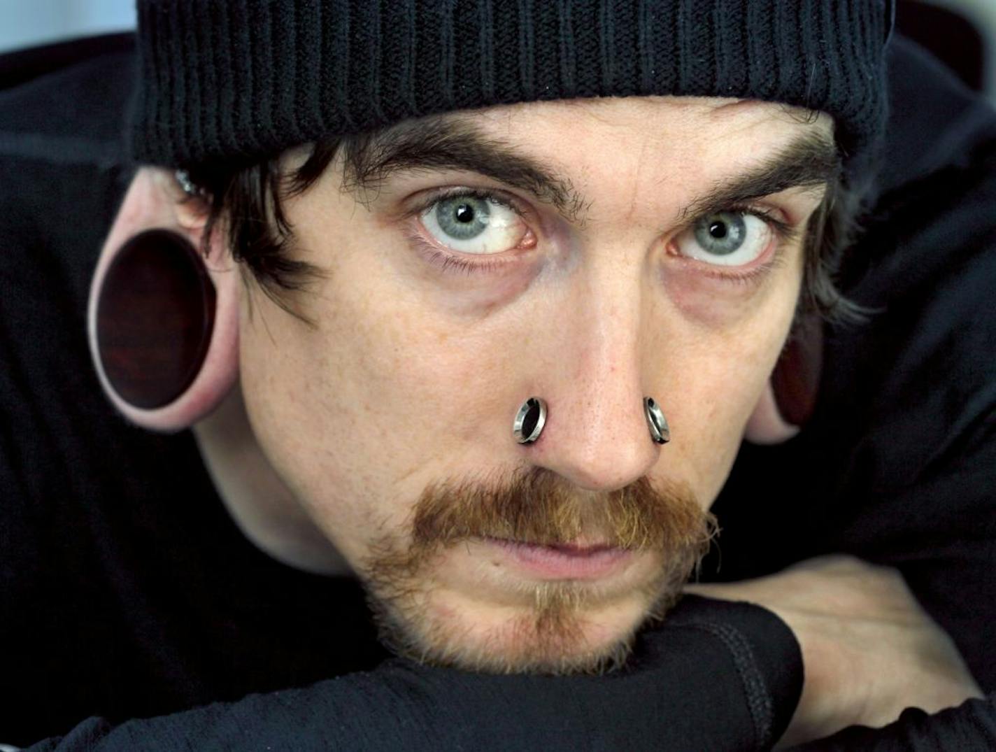 James Clark, who has been piercing ears for 15 years, stretched his own lobes out to more than 2 inches is considering getting surgery to reduce them.