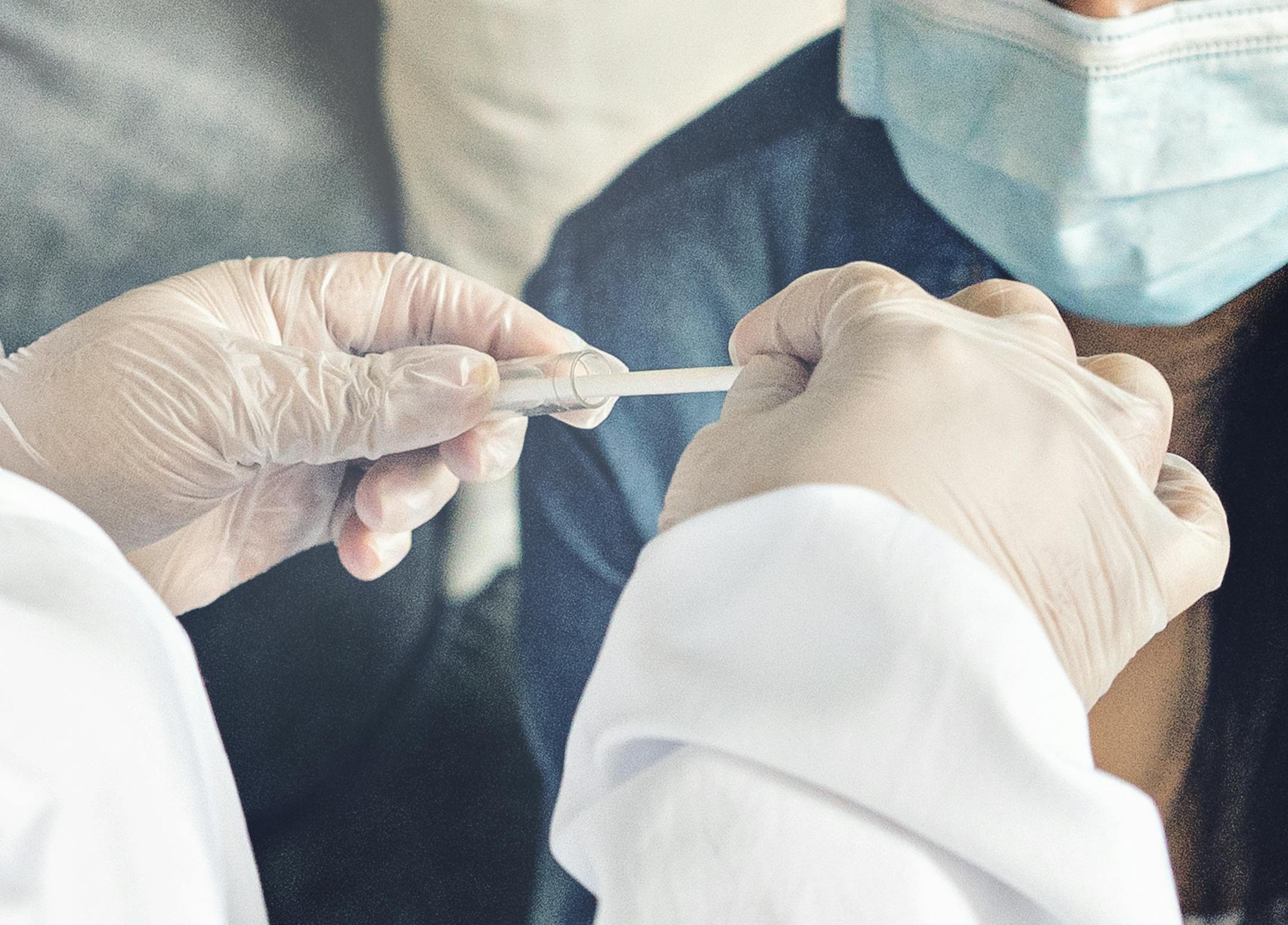A doctor in a protective suit performs a Coronavirus test for the Covid-19 virus. pandemic concepts