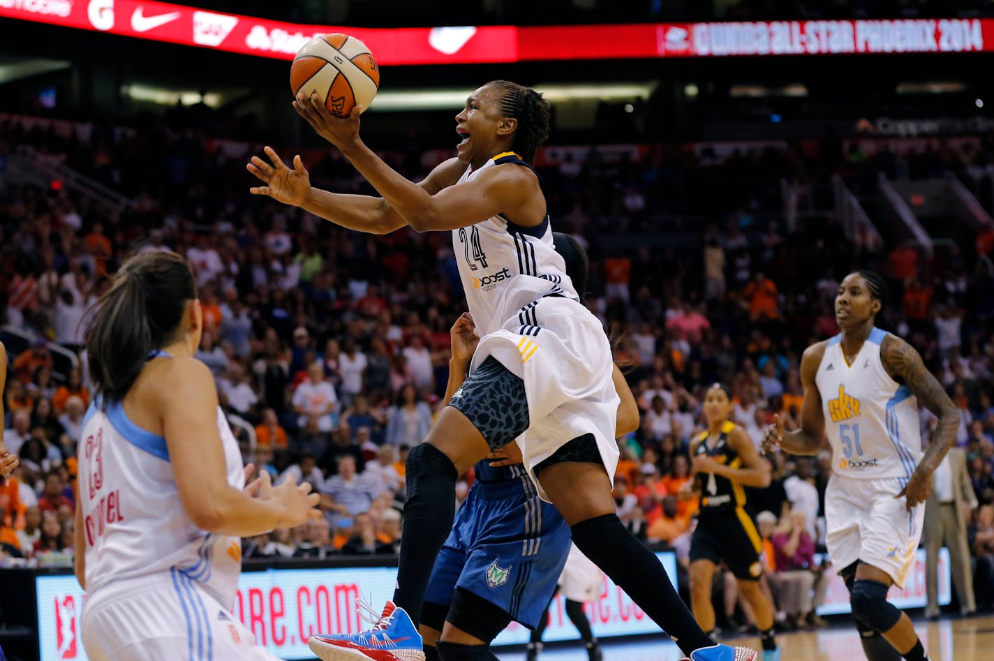 In this July 19, 2014, photo, the East's Tamika Catchings, of the Indiana Fever, scored the winning basket during overtime of the WNBA All-Star Game in Phoenix. The spotlight will be on Catchings who is playing in a record 10th WNBA All-Star Game on Saturday.