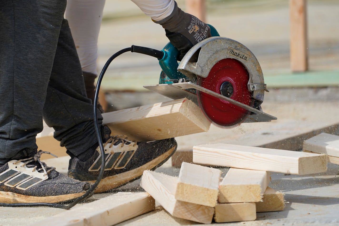 A workman cuts sections of a beam at a housing site in Madison County, Miss., Tuesday, March 16, 2021. The busy season for home remodeling usually ends in late summer or early fall, but contractors say demand from the pandemic renovation rush hasn't let up. (AP Photo/Rogelio V. Solis)