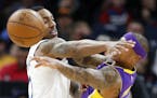 Minnesota Timberwolves guard Jeff Teague (0) defends as Los Angeles Lakers guard Isaiah Thomas (7) passes the ball during the first half.