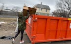 Business owner Anissa Keyes tackled another round of trash removal. She purchased the historic Camden Park State Bank building in north Minneapolis, h
