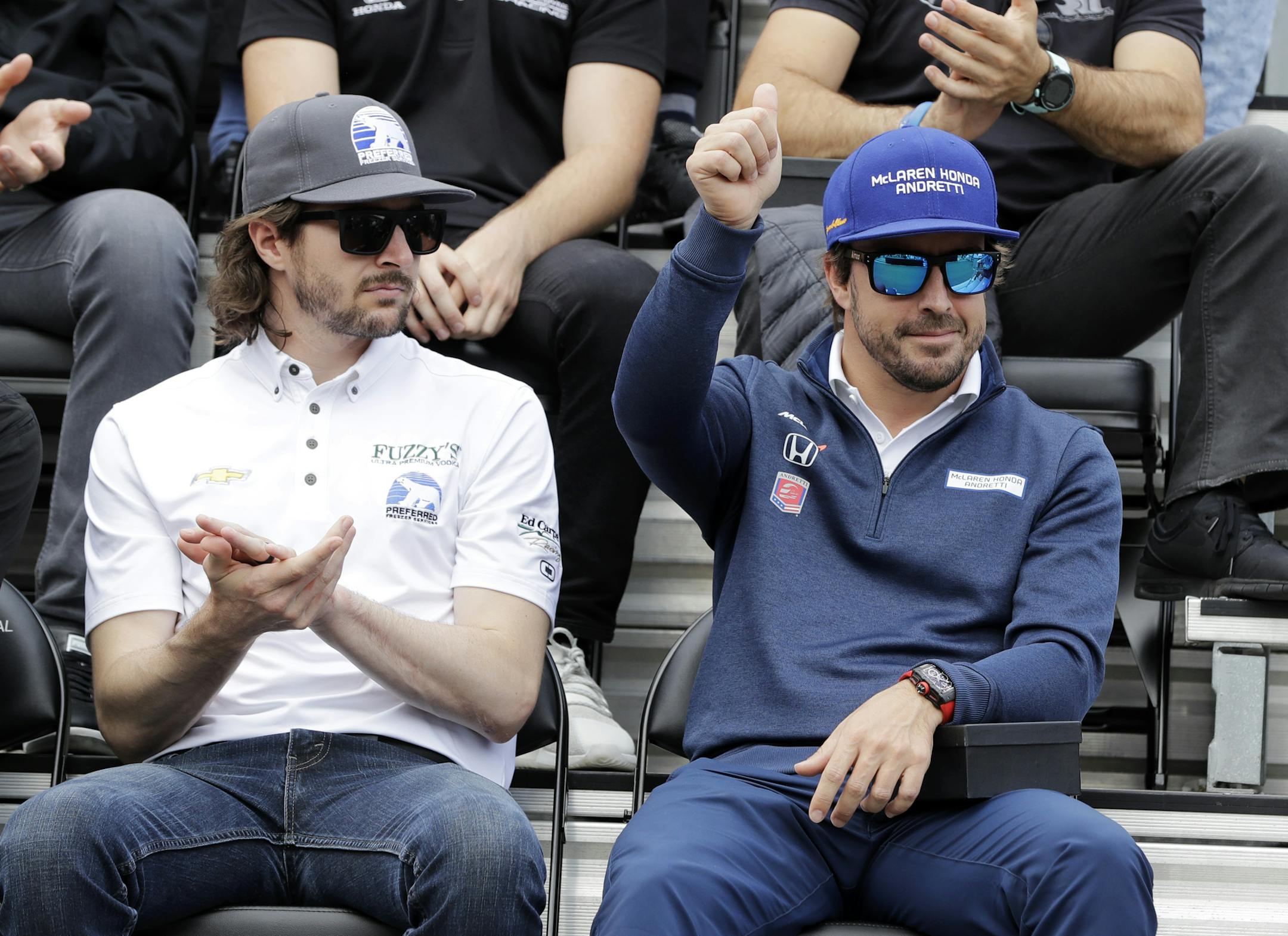Fernando Alonso, of Spain, waves as he introduced during the drivers meeting for the Indianapolis 500 auto race at Indianapolis Motor Speedway, Saturday, May 27, 2017 in Indianapolis. The 101st running of the race is Sunday. JR Hildebrand is at the left. (AP Photo/Darron Cummings)