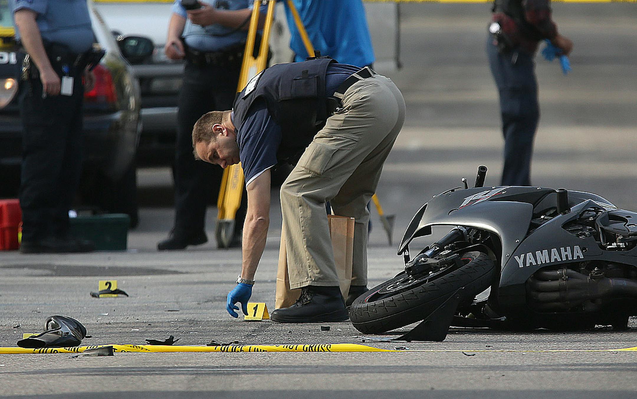 Minneapolis police officers surveyed the scene where a police vehicle and motorcycle collided at the intersection of Blaisdell and 26th in Minneapolis, Min., Friday, May 10, 2013.