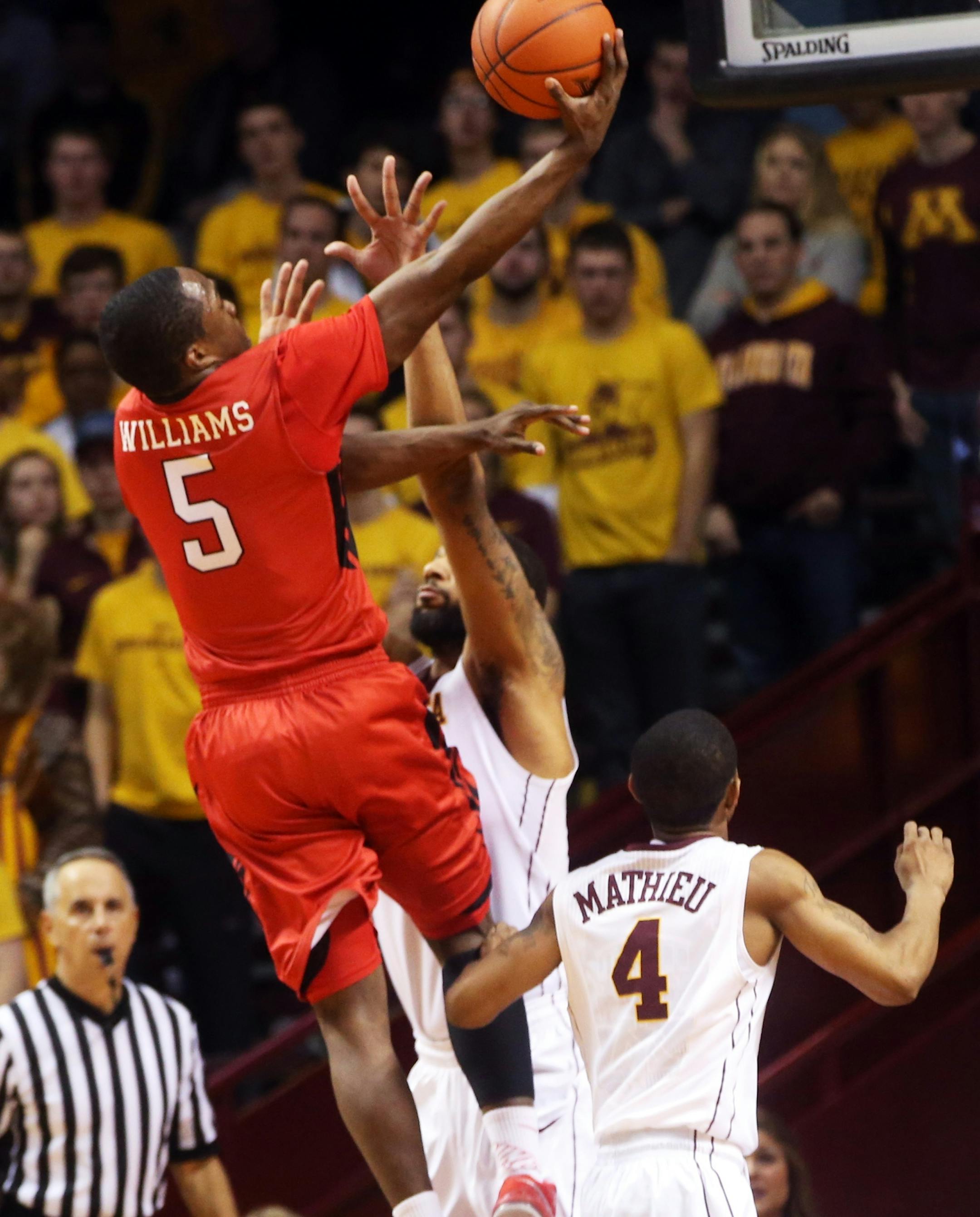 Rutgers&#x2019;s Mike Williams, left, lays up over Minnesota&#x2019;s Maurice Walker in the second half of an NCAA college basketball game, Saturday, Jan. 17, 2015, in Minneapolis. Minnesota won 89-80. (AP Photo/Jim Mone)