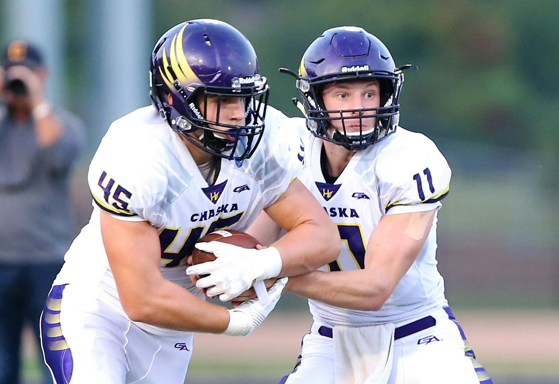 Chaska senior QB Connor Souba hands off two sophomore RB Marcus Holasek who barrels up the middle for the Hawks in first half action against Chanhassen at Chanhassen HS on Friday, September 15th. Photo by Brian W Nelson
