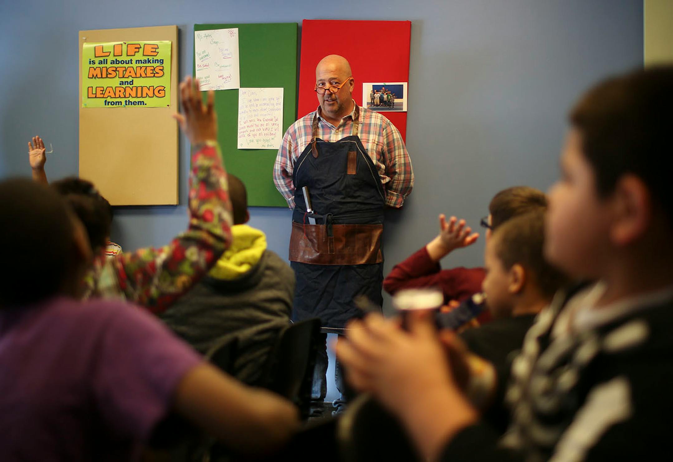 Travel Channel host (and Twin Cities resident) Andrew Zimmern stopped by the Salvation Army's Payne Ave. location in St. Paul to cook with chef Jeff Ansorge, former head chef at the Captal Grille in Minneapolis, as he prepared a meal Monday afternoon, March 3, 2014 for donors and volunteers. Antwan Zimmern asked all the kids who helped make posters (to thank him for his visit) to raise their hands when he dropped by to visit with Antwan Flowers' after school program at the Salvation Army's Easts