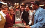 Lori, Yevette, Clem, Clemette and Brent Haskins get their arms around the Big Ten trophy during the home celebration after the Gophers won the Big Ten