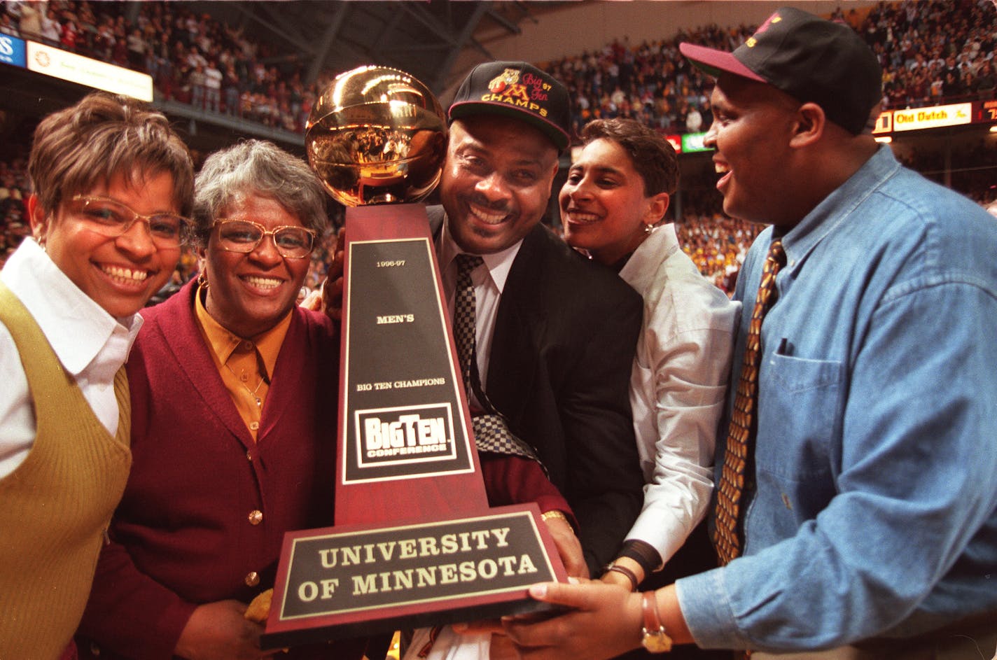 Lori, Yevette, Clem, Clemette and Brent Haskins get their arms around the Big Ten trophy during the home celebration after the Gophers won the Big Ten Championship in Michigan. The celebration occured March 6th before their last home game of the regular season against Michigan State.