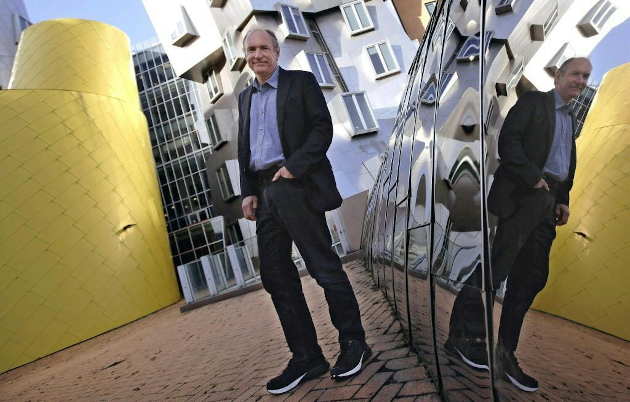 In this Monday, April 3, 2017, photo, Tim Berners-Lee poses outside his office at the Massachusetts Institute of Technology in Cambridge, Mass. Berners-Lee, best known as the inventor of the World Wide Web, is this year's recipient of the A.M. Turing Award, computing's version of the Nobel Prize. The honor comes with a $1 million prize funded by Google, one of many companies that made a fortune thanks to Berners-Lee's efforts to make the internet more accessible and useful.
