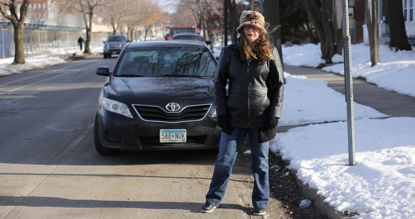 Patricia Fox stands by her vehicle, which is parked in a designated disability parking spot, in front of her Fremont Avenue home in North Minneapolis on Friday, April 6, 2018. Fremont Avenue and neighboring Emerson Avenue will undergo bike lane changes, causing Fox's and five other disabled individuals' parking spots to move further from their homes. [Ellen Schmidt &#x2022; ellen.schmidt@startribune.com