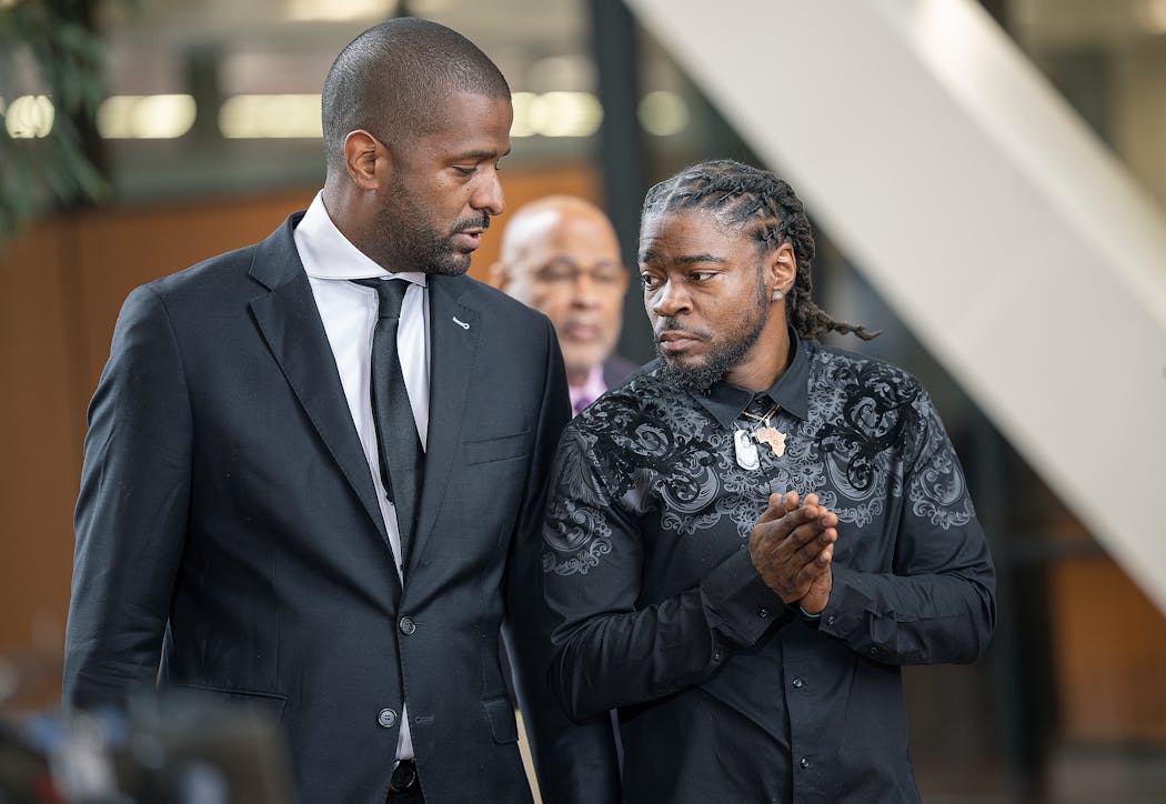 Ricky Cobb’s twin brother Rashad Cobb, right, and attorney Bakari Sellers, make their way to a press podium to address the media about the lawsuit the family is filing against Minnesota State Trooper Ryan Londregan at the Hennepin County Government Center in Minneapolis on Wednesday.