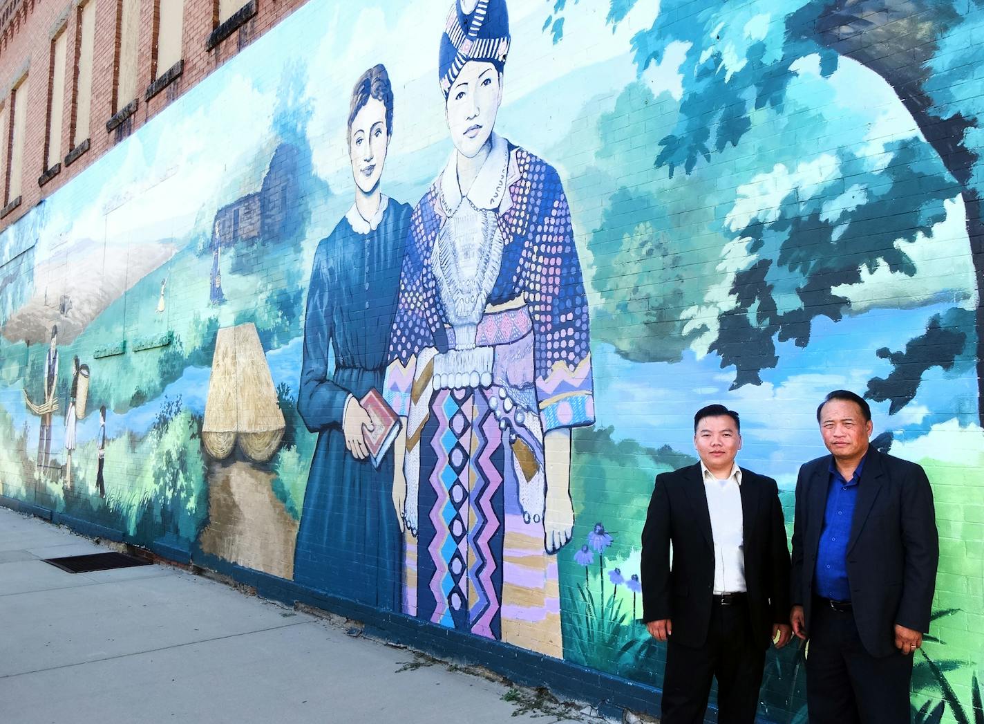 Xiong Yang is in the white shirt, to the left in the photo. He's a Walnut Grove City Council person. Terry Yang is in blue to the right. He was one of the first Hmong to move to Walnut Grove, following his brother, Harry's, lead. The mural was completed in the summer of 2012 by Rochester, Minnesota artist Greg Wimmer. It's on the side of the only grocery story in town, Bubai Foods, owned by Terry and Harry Yang. (Bubai means butterfly in Hmong.) Xiong Yang helped with the mural effort. Here's a