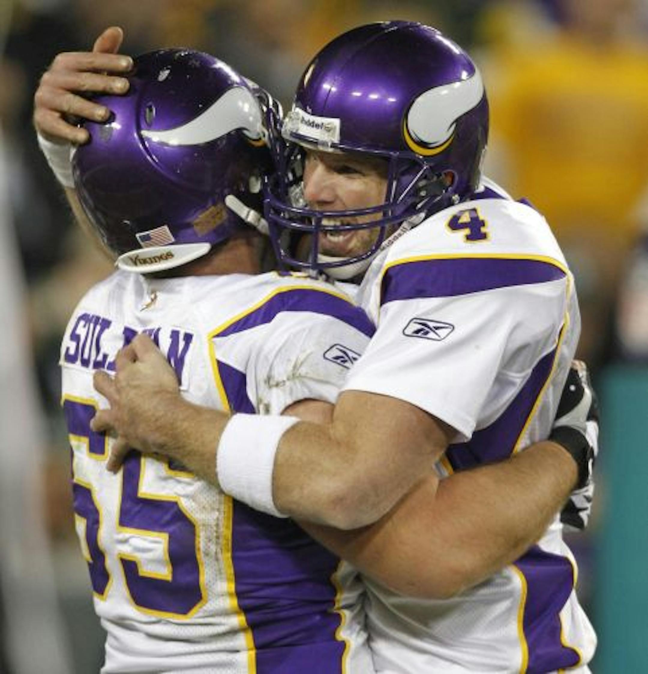 Minnesota Vikings quarterback Brett Favre (4) hugs John Sullivan, left, after Favre threw a fourth-quarter touchdown pass against the Green Bay Packers during an NFL football game Sunday, Nov. 1, 2009, in Green Bay, Wis. The Vikings won 38-26.