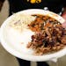 FILE - A plate of food is held on Aug. 6, 2023, in Cedar Rapids, Iowa. A new United Nations report estimates that 19% of the food produced around the 