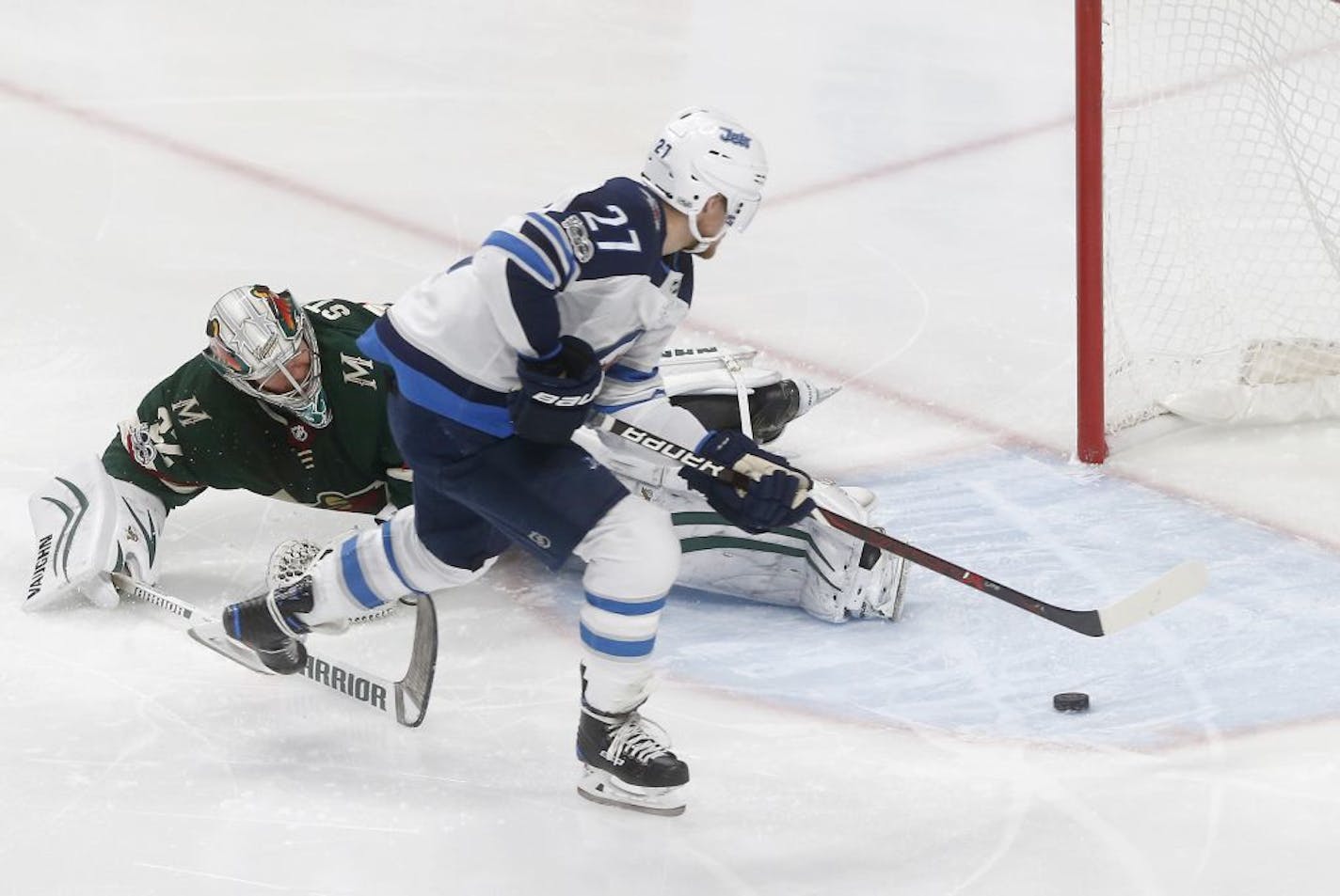 Winnipeg Jets' Nikolaj Ehlers, right, of Denmark, skates past Minnesota Wild goalie Alex Stalock to score during the third period of an NHL hockey game Tuesday, Oct. 31, 2017, in St. Paul, Minn. The Jets won 2-1.