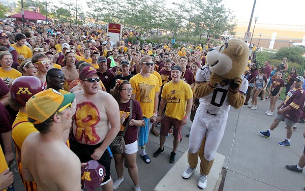 Gold Gopher swoons a crowd at the entry gate before the Gophers took on TCU