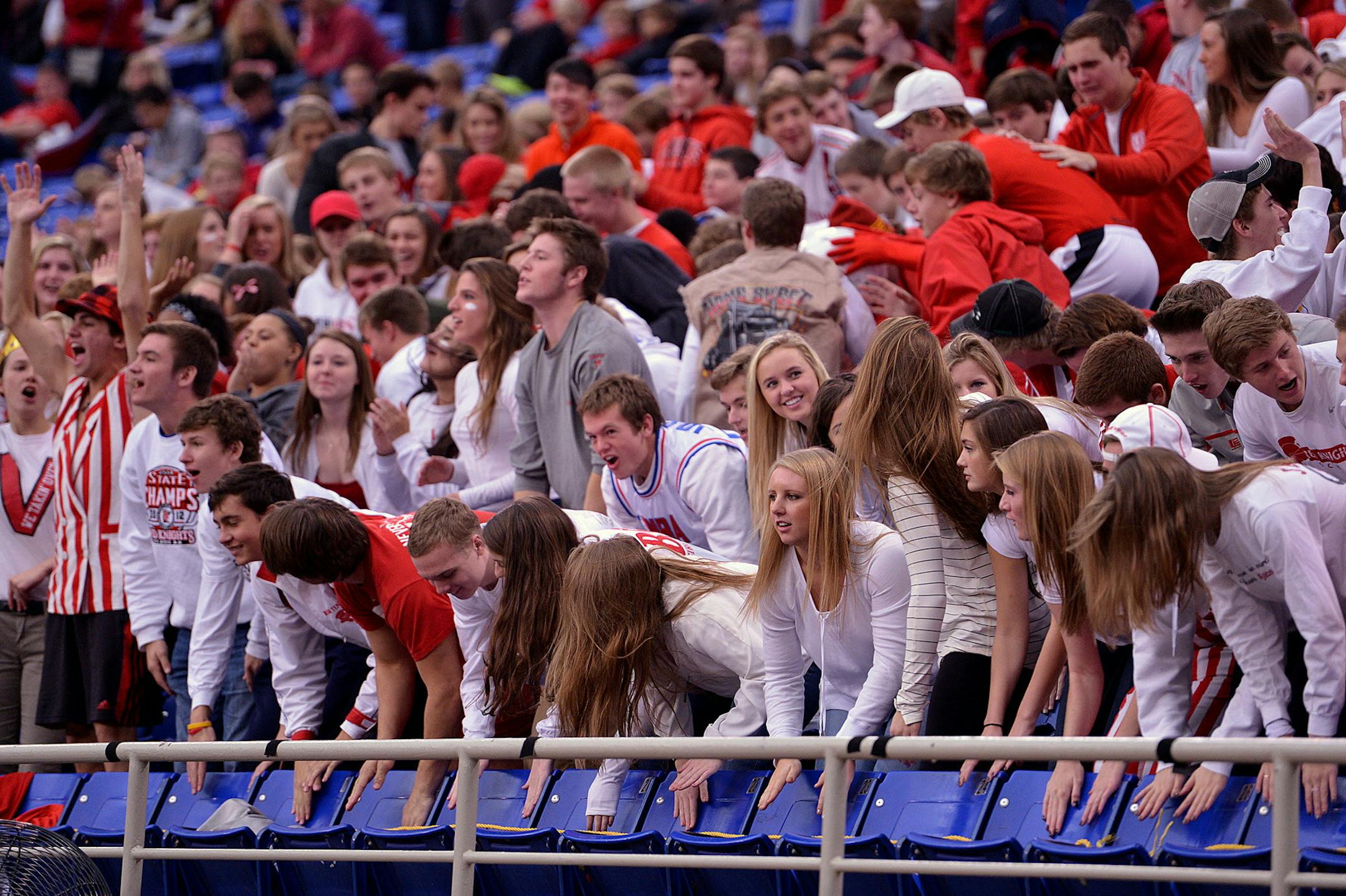 Benilde- St. Maragret fan cheer for the Red Knights during the first half of the Class 1A Girls' state soccer semifinal game Monday, October 28 at Metrodome. Benilde's 5-1 sends them to the state final against the Blake School. ] (SPECIAL TO THE STAR TRIBUNE/BRE McGEE)