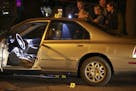 Investigators from the Minneapolis Police Department crime lab documented evidence around the car where a stabbing took place in Dinkytown Thursday ni